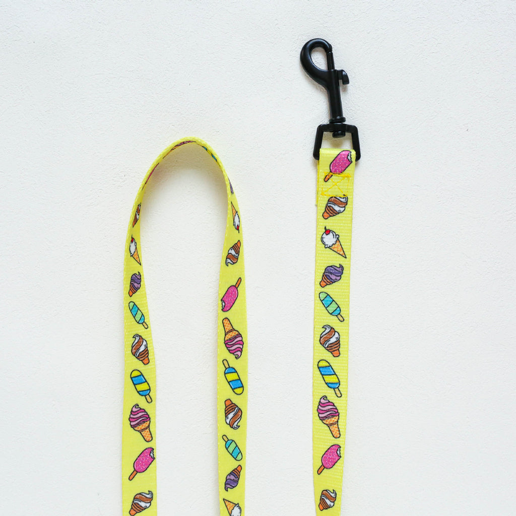 Yellow dog leash with ice cream cone pattern on a white background
