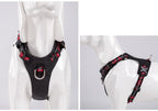 Black dog harness with red plaid pattern on a mannequin against a white background.
