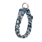 Floral-patterned dog collar with a metal clasp on a white background