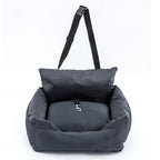 Gray pet carrier with a pillow and strap on a white background