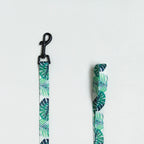 Tropical leaf patterned strap with clip on a white background