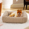 Dog lying on a plush pet bed in a home setting