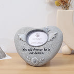 Heart-shaped pet memorial with engraved text on a wooden surface