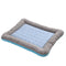 A rectangular cooling pet mat with a blue center and a striped pattern border in a folded view.