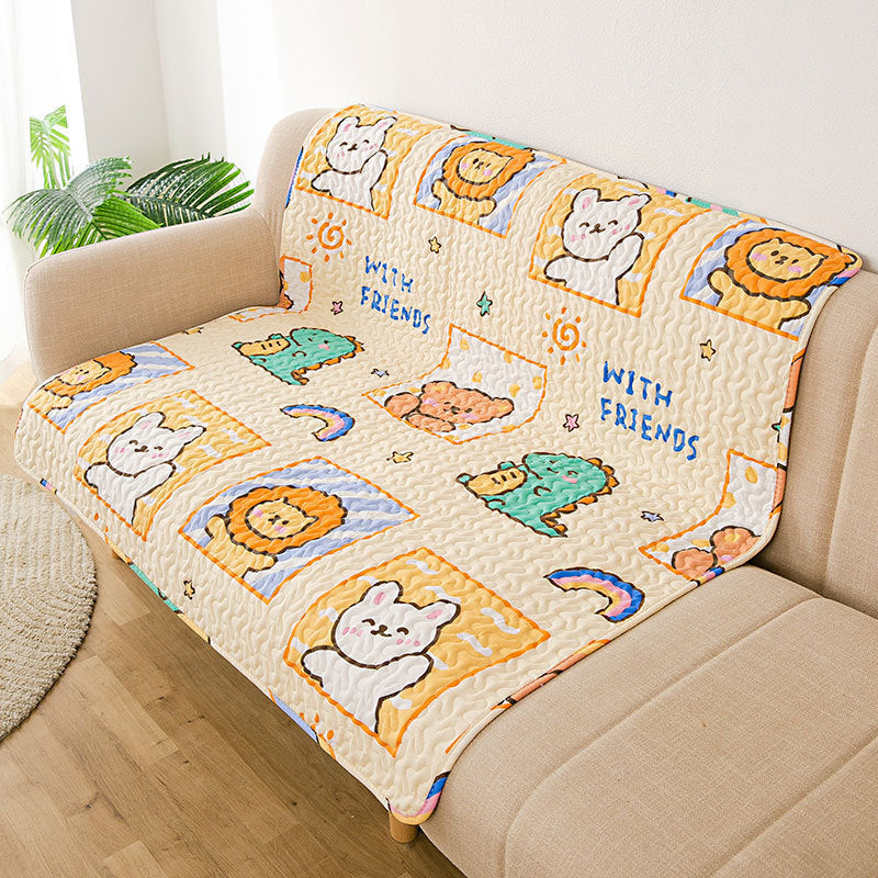 Children's cartoon blanket with animals and 'WITH FRIENDS' text on a beige couch.