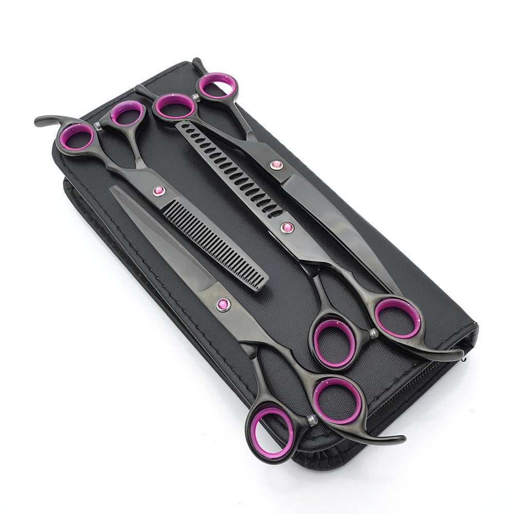 Set of black and purple hairdressing scissors in a black case on a white background