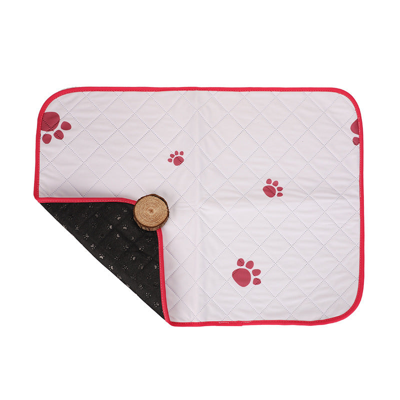 Quilted pet mat with red paw prints on a white background